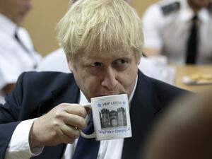 Britain's Prime Minister Boris Johnson drinks from a HMP Leeds prison mug (AFP/ File Photo)