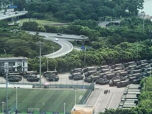 Trucks and armoured personnel carriers are seen outside the Shenzhen Bay stadium in Shenzhen, bordering Hong Kong in China's southern Guangdong province, on August 15, 2019. (AFP/ File Photo)