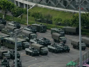 Trucks and armoured personnel carriers are seen parked at the Shenzhen Bay stadium in Shenzhen, bordering Hong Kong in China's southern Guangdong province, on August 16, 2019. (AFP)