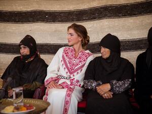 Queen Rania greets an elderly woman during a vist to Umm Al Rasas District in Amman on Wednesday. (Twitter/ @QueenRania)