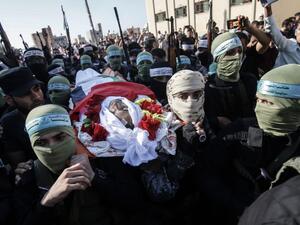 Palestinian fighters from the Fatah movement carry the shrounded body of Badreddin Abu Musa during his funeral procession in the city of Khan Yunis, in the southern Gaza Strip on August 31, 2019. (AFP/ File Photo)