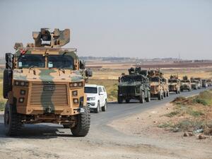 A picture taken on September 1, 2019 shows a convoy of Turkish military vehicles passing through the village of Kafr Halab on the western edge of Aleppo province.  (Omar HAJ KADOUR / AFP)