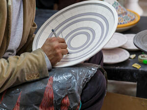 Artisan is painting dish, Berber style in ceramic factory, Fex Medina, Morocco. (Shutterstock/ File Photo)