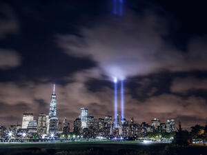 Illuminated Manhattan skyline with two beams of light in memory of 9/11 (Shutterstock)	