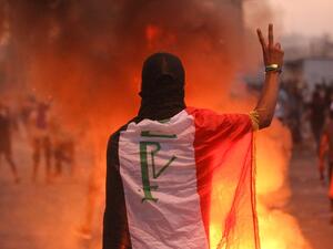 An Iraqi protester gestures the v-sign during a demonstration against state corruption, failing public services and unemployment at Tayaran square in Baghdad on October 2, 2019. (AFP/ File Photo)