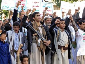 Supporters of Yemen's Shiite Huthi rebels chant slogans and raise signs showing the group's flag, reading in Arabic "God is Great, death to America, death to Israel, curse upon the Jews, victory to Islam", as they gather for a rally in support of the group in the Huthi-held capital Sanaa on October 4, 2019. MOHAMMED HUWAIS / AFP
