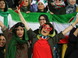 Iranian women cheer during the World Cup Qatar 2022 Group C qualification football match between Iran and Cambodia at the Azadi stadium in the capital Tehran on October 10, 2019. ATTA KENARE / AFP