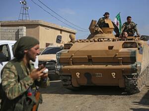 Turkish-baked Syrian fighters drive an armoured personnel carrier near the Syrian border town of Tal Abyad on October 12, 2019, as they prepare to take part in the Turkish-led assault on northeastern Syria. Bakr ALKASEM / AFP