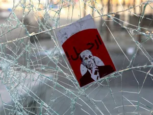A placard depicting Lebanese President Michel Aoun with the words "Go Away" is seen amidst the debris at Riad al-Solh Square in the centre of the capital Beirut  (AFP)