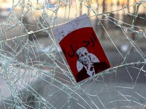 A placard depicting Lebanese President Michel Aoun with the words "Go Away" is seen amidst the debris at Riad al-Solh Square in the centre of the capital Beirut  (AFP)