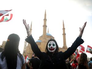 A Lebanese demonstrator, her face painted as DC comic book and film character "The Joker", takes part in a protest in the capital Beirut's downtown district's Martyr's Square on October 19, 2019. (AFP/ File Photo)
