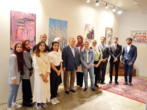 Saudi Arabia’s permanent representative to the UN Abdallah Al-Mouallimi, center, with the exhibition’s volunteers and guests on the opening day. (Photo/Supplied/ Arab News))