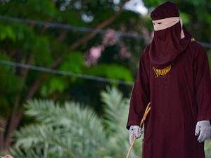 A member of the Sharia police can be seen standing ahead of the public caning in Banda Aceh on October 21, 2019 (AFP/dailymail.co.uk)