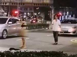 Shocking footage shows the 31-year-old chasing and yelling out to the taxi driver around 2am on Middle Road in Singapore. (Facebook/@ROADS.sg)