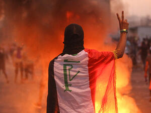 An Iraqi protester gestures the v-sign during a demonstration against state corruption, failing public services and unemployment at Tayaran Square in Baghdad. (AHMAD AL-RUBAYE/AFP)
