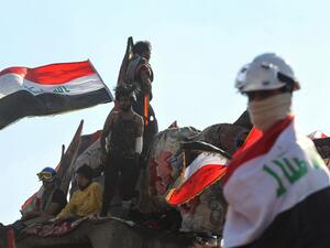 Iraqi protesters gather on al-Jumhuriya bridge which leads to the high-security Green Zone, during ongoing anti-government demonstrations in the capital Baghdad (AFP)