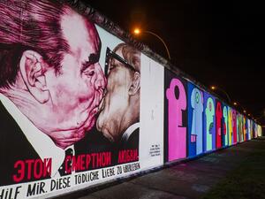 The mural painting "My God, Help Me to Survive This Deadly Love" by Russian painter Dmitri Vrubel, depicting the kiss between then Soviet leader Leonid Brezhnev (L) and East German leader Erich Honecker is projected on a stretch of the Berlin wall at the so-called East-side Gallery during the city-wide kick-off of the festival week to celebrate the 30th anniversary (AFP)