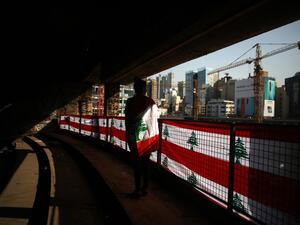 A Lebanese student clad with the national flag looking at the downtown area of the capital Beirut from within The Egg (the Dome), an unfinished cinema structure built in 1965, amid ongoing anti-government demonstrations. Thousands of students took to the streets across Lebanon today to demand a better future as an unprecedented anti-government protest movement entered its fourth week and continued to spread. Patrick BAZ / AFP