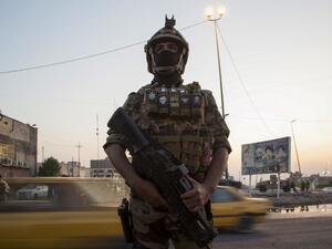A picture taken on November 9, 2019, shows a Iraq security forces standing guard outside a government building during ongoing anti-government demonstrations in the southern city of Basra. Seven protesters were killed in Iraq as security forces cleared protest sites in Baghdad and Basra after political leaders agreed to stand by the embattled government by any means. Hussein FALEH / AFP