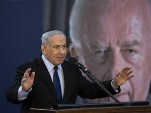 Israeli Prime Minister Benjamin Netanyahu speaks during a state memorial ceremony for former Israeli prime minister Yitzhak Rabin (backround) and his wife Leah, at Mount Herzl in Jerusalem on November 10, 2019.  (HEIDI LEVINE / POOL / AFP) Israeli Prime Minister Benjamin Netanyahu speaks during a state memorial ceremony for former Israeli prime minister Yitzhak Rabin (backround) and his wife Leah, at Mount Herzl in Jerusalem on November 10, 2019.  (HEIDI LEVINE / POOL / AFP)