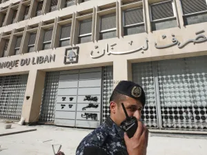 A member of the Lebanese security forces stands at the entrance of the Central Bank after anti-government protesters broke down a construction barrier as they rally at the same time of a press conference held by the bank's governor in Beirut on November 11, 2019. (AFP/ File Photo)