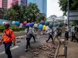 Protesters are escorted out of the main entrance to Hong Kong Polytechnic University campus in the Hung Hom district in Hong Kong on November 19, 2019. (AFP/ File Photo)