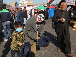 An Iraqi youth, wearing the DC comic Joker character's make up, smiles to the camera in Baghdad's Tahrir Square as anti-government protests continue across the country on November 20, 2019. (AFP/ File Photo)