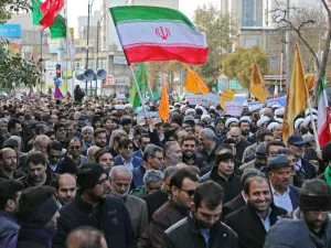 Iranians wave a national flag (R) during a protest in support of the Islamic republic's government and supreme leader, Ayatollah Ali Khamenei, in the northwestern city of Ardabil on November 20, 2019 (AFP/ File Photo)