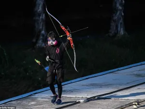 A protester wielding a bow and arrow walks along a footbridge roof. Hong Kong returned to Chinese rule under a 'one country, two systems' formula guaranteeing its colonial-era freedoms. (AFP/ File)