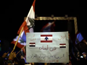 A Lebanese anti-government protester holds a placard readingin Arabic “From Lebanon to Iraq”, during a rally in the capital Beirut's downtown district on November 30, 2019. More than a month into unprecedented anti-government protests, Lebanon is facing a dual political and economic crisis. Patrick BAZ / AFP