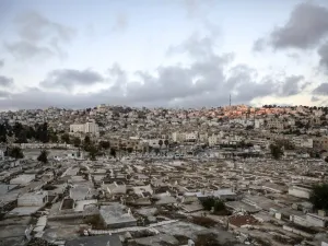 City of Hebron in the occupied West Bank shows a view of a Palestinian cemetery (foreground), an old market building (C) along al-Shuhada street that was newly-announced by the Israeli defence minister to be designated as a new settlement, with existing Israeli settler buildings behind (AFP) 