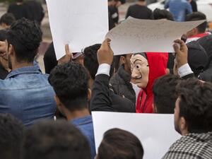 An Iraqi demonstrator wearing the red jumpsuit and Dali mask of the Spanish Netflix hit series La Casa de Papel (Money Heist), takes part in an anti-government march in the center of the southern city of Basra on December 2, 2019. (AFP/ File Photo)
