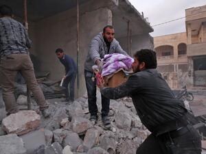 Residents salvage belongings from the rubble of a building following a reported air strike by pro-regime forces in the Syrian town of Saraqib in the northwestern Idlib province on December 4, 2019. (Omar HAJ KADOUR / AFP)
