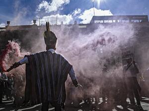 An indigenous man holds a flare during a protest against Colombian President Ivan Duque at the Bolivar square in Bogota, on December 4, 2019. (AFP/ File Photo)