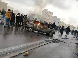 Iranian protesters gather around a burning car during a demonstration against an increase in gasoline prices in the capital Tehran, on November 16, 2019. (AFP/File)