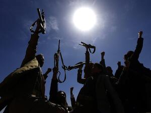 In this file photo taken on February 21, 2019, armed Yemeni men raise their weapons as they gather near the capital Sanaa to show their support to the Shiite Huthi movement against the Saudi-led intervention. (Mohammed HUWAIS / AFP)