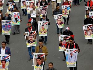 Iraqis hold pictures of killed demonstrators in the capital Baghdad's Tahrir Square, amid ongoing anti-government protests, on December 6, 2019. Tahrir has become a melting pot of Iraqi society, occupied day and night by thousands of demonstrators angry with the political system in place since the aftermath of the US-led invasion of 2003 and Iran's role in propping it up. AHMAD AL-RUBAYE / AFP