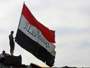 An Iraqi demonstrator waves a large national flag in the capital Baghdad's Tahrir Square, amid ongoing anti-government protests, on December 6, 2019. AFP