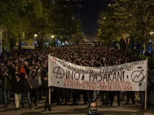 People carry a giant banner reading "They shall not pass" as they march in central Athens on December 6, 2019 after a rally commemorating the death of a 15-year-old teenager, who was fatally shot by a police officer in 2008. (AFP/ File Photo)