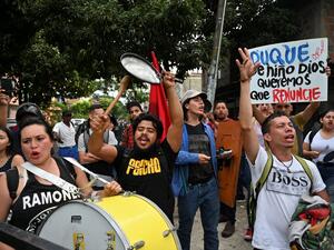 People demonstrate demanding the resignation of Colombian President Ivan Duque, upon his arrival at the community hall of the Aguablanca neighborhood, in Cali, Colombia, on December 6, 2019, to attend a national dialogue convened in response to protests against his government. Luis ROBAYO / AFP