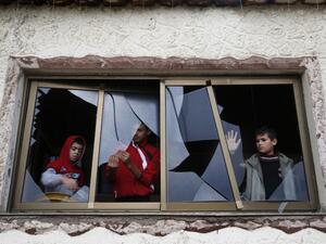 Palestinian boys pull shards of glass from a broken window at their home near the site of Israeli overnight attacks in Gaza City on December 8, 2019. (AFP/ File Photo)