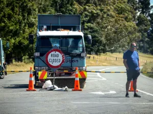 This photo taken on December 8, 2019 shows an official standing in front of a road block after the Rakaia River rose to dangerous levels, near the town of Geraldine on New Zealand's South Island. (AFP/ File Photo)
