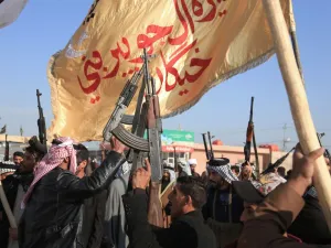 Armed members of Karbala clans lift their guns as they take to the streets to declare their support to the Iraqi armed forces to prohibit trouble makers from entering the southern Shiite shrine city on December 8, 2019. (AFP/ File Photo)