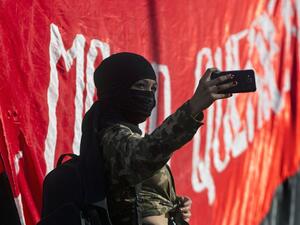 a demonstrator poses for a selfie during a protest against the government economic policies in Santiago, a day after more than one million people took to the streets for the largest protests in a week of demonstrations. AFP/ File