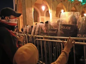 Lebanese demonstrators confront security forces in the capital Beirut on December 15, 2019. Lebanese police clashed with anti-government protesters in Beirut late Sunday, firing tear gas to prevent them from breaching barricades near parliament, ANWAR AMRO / AFP