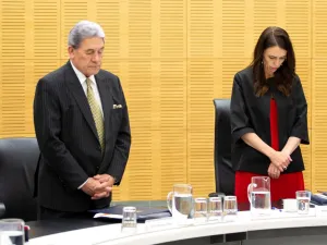 New Zealand Prime Minister Jacinda Ardern (C) and Deputy Prime Minister Winston Peters stand with cabinet ministers as they observe a minute's silence in respect for victims of the December 9 White Island volcanic eruption, at Parliament in Wellington on December 16, 2019. (AFP/ File Photo)