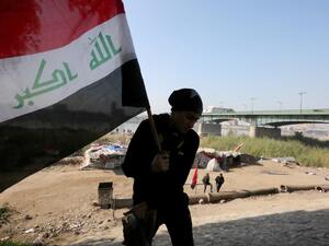 An Iraqi protestor leaves a camp site next to al-Jumhuriyah (Republic) Bridge spanning the River Tigris in the heart of Baghdad on December 18, 2019. SABAH ARAR / AFP