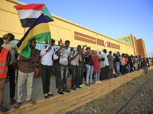 Sudanese protesters wait at a train station in Khartoum to board a train to Atbara on December 19, 2019 to celebrate the one-year anniversary of their protest movement that brought down Omar al-Bashir last April after a thirty-year rule. A year after demonstrations broke out in Sudan over soaring bread prices, celebrations are planned across the country to mark the uprising that brought down veteran autocrat Bashir.  ASHRAF SHAZLY / AFP