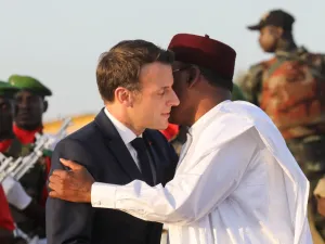 France's President Emmanuel Macron (L) is greeted by Niger's President Mahamadou Issoufou as they take part in a military ceremony at the Martyr Quarter on December 22, 2019, in Niamey, to pay homage to 71 Nigerien soldiers massacred in an attack on December 10 at the Inates military camp in the Sahel country's western Tillaberi region. Ludovic MARIN / POOL / AFP