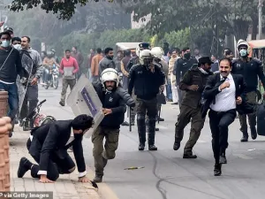 Policemen chase lawyers following a clash between lawyers and doctors in Lahore today (AFP/ File Photo)